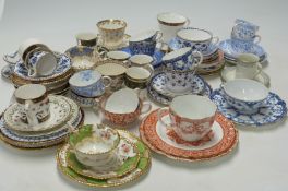 A collection of tea cups and saucers and coffee cans including Crown Derby and Spode examples