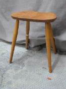 Ercol light elm four legged shaped stool or side table,