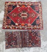 Handmade woollen rug on red ground,