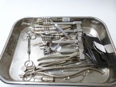 A stainless steel tray of surgical instruments, mainly early 20thC,