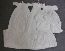 Collection of vintage christening gowns including broderie anglaise and lace trimmed