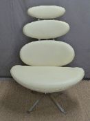 A designer chrome and leather effect pebble swivel chair with graduated design,