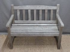 A child's teak two seat garden bench,