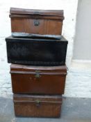 Four vintage metal or metal bound trunks,