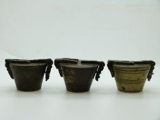 Three similar sets of brass or bronze cup weights with marks to tops