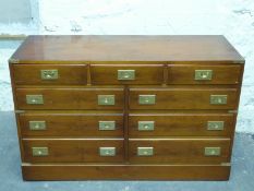 A campaign style chest of three over six drawers,