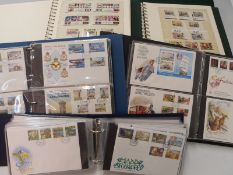 Four albums of Isle of Man stamps 1973-2000 and an album of first day covers