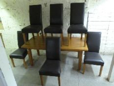 A contemporary light oak dining table and six leather chairs,