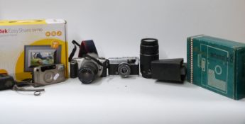 A collection of vintage cameras and home movie equipment to include Olympus Trip 35,