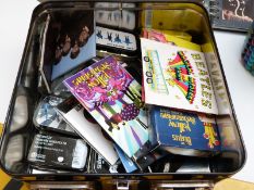 A collection of Beatles memorabilia including tins, notebooks, badges, magnets, mirror etc,