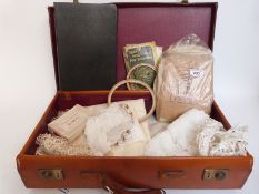 A quantity of early 20thC lace together with a sample book, embroidery hoops etc,