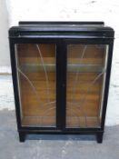 Art Deco glazed display cabinet with leaded sunburst design to doors,