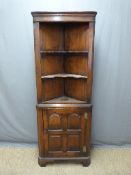 Oak corner cupboard with shelves to top and panelled door below H179cm