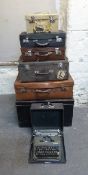 Five trunks/suitcases and a typewriter