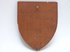 A shield shape wooden plaque signed by Surrey cricketers c1950 including Tom Clark and Bernie