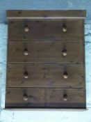 A stained pine chest of two over three drawers,