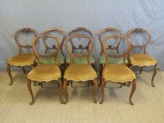 Harlequin set of eight Victorian mahogany balloon back chairs with serpentine seats raised on