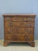 An 18thC walnut and mahogany chest of three over three graduated drawers with feathered inlaid