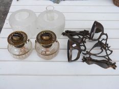 A pair of Arts & Crafts / Art Nouveau hammered copper oil lamps with glass shades