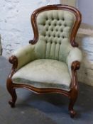 A Victorian style mahogany upholstered chair
