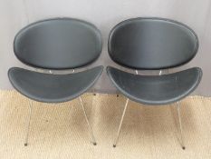 A pair of designer leather and chrome chairs,