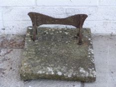 A 19thC metal foot scraper set in stone,