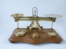William Mitchell's improved postage or parcel scales with weights to wooden base,