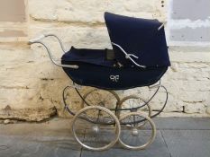 Silver Cross vintage dolls pram in navy blue with silver bow detail to the side has hood and cover,