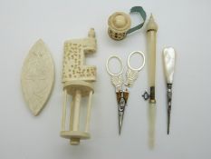 A group of mother of pearl and bone sewing accessories to include spool holder,