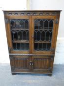 Old Charm or similar oak glazed bookcase with cupboard below,