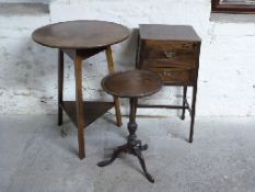 An oak two drawer bedside table, oak cricket table and a wine table,