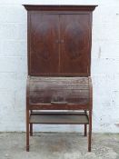 A tambour fronted secretaire with flame mahogany inlaid doors,