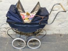 A vintage double ended pram in navy with two hoods together with Barbie dolls and clothing