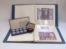 Two albums of Elvis Presley stamps,