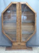 Art Deco octagonal walnut glazed display cabinet with single drawer, on shaped pedestal base,