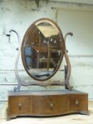 A 19thC mahogany bevelled glass drawing table mirror with serpentine front,