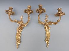 A pair of brass double candle wall sconces,