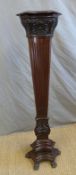 a 19thC or early 20thC mahogany jardinere stand or plinth of triform with reeded and carved