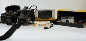 A collection of vintage cameras including Polaroid Instant 10,
