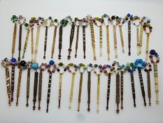 A collection of largely Victorian lace making bobbins including bone,