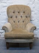 A contemporary upholstered button back armchair