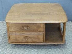 Ercol golden elm Pandora coffee table with two drawers and cubbyholes,