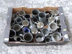 A quantity of pewter tankards,