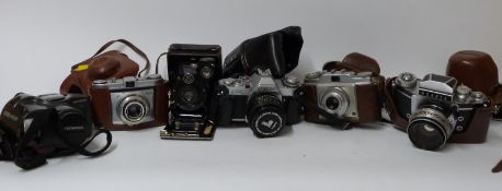Quantity of cameras and accessories including Canon AV1 with 50mm 1:1.
