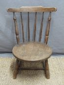 A cut down child's elm chair
