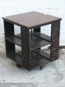 Early 20thC carved oak revolving bookcase with griffon, unicorn, dog and lion decoration,