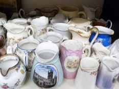 A collection of milk and cream jugs including Spode,