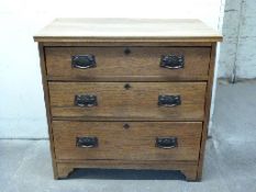 Art Nouveau oak chest of three graduated drawers,