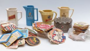 A collection of Wade and other whisky water jugs and a large collection of vintage beer mats etc