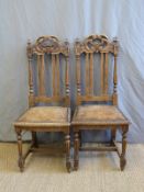 A 19thC pair of upholstered oak hall chairs